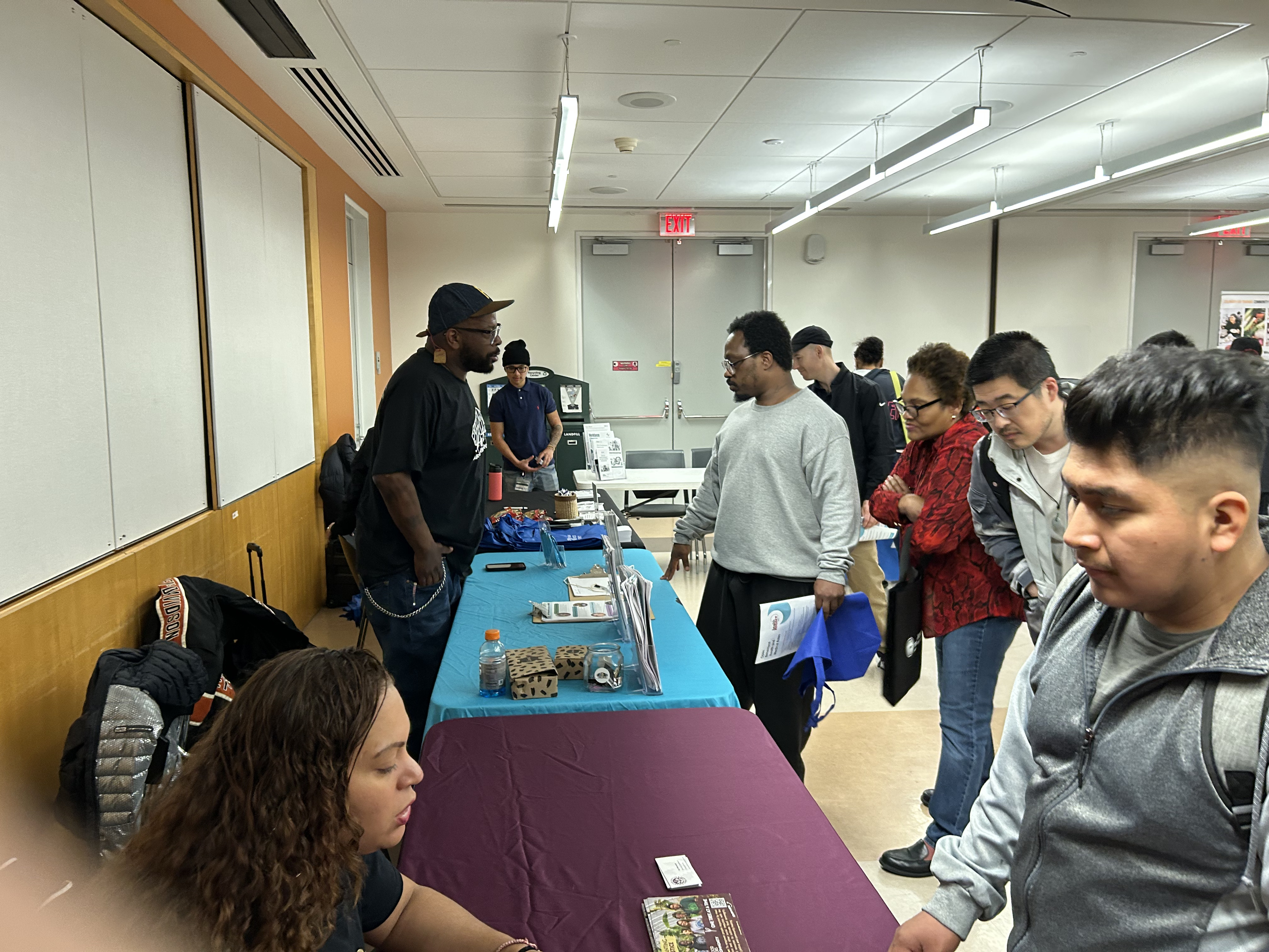 Community outreach event with residents at an information table.